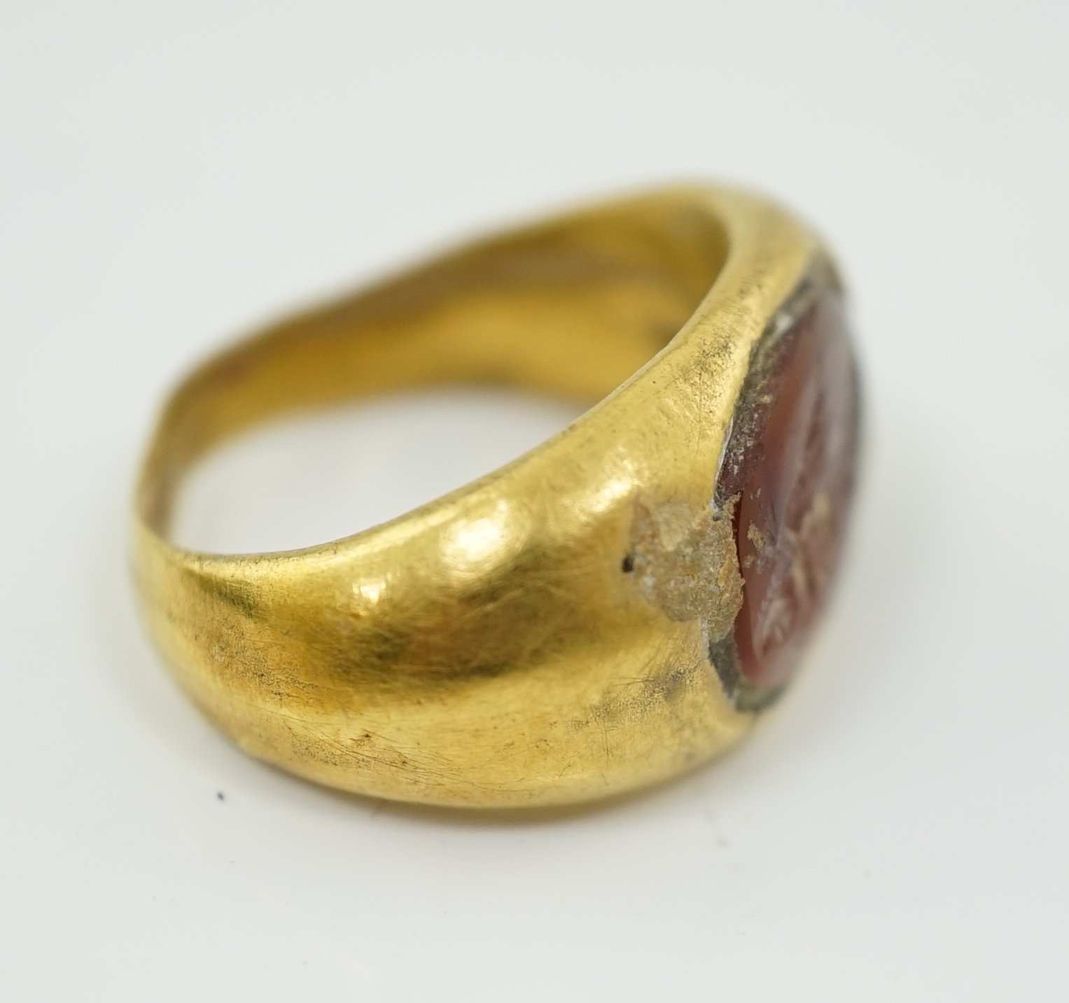 A Greco-Roman gold and intaglio carnelian set finger ring, carved with the figure of Nike, circa 1st century B.C.